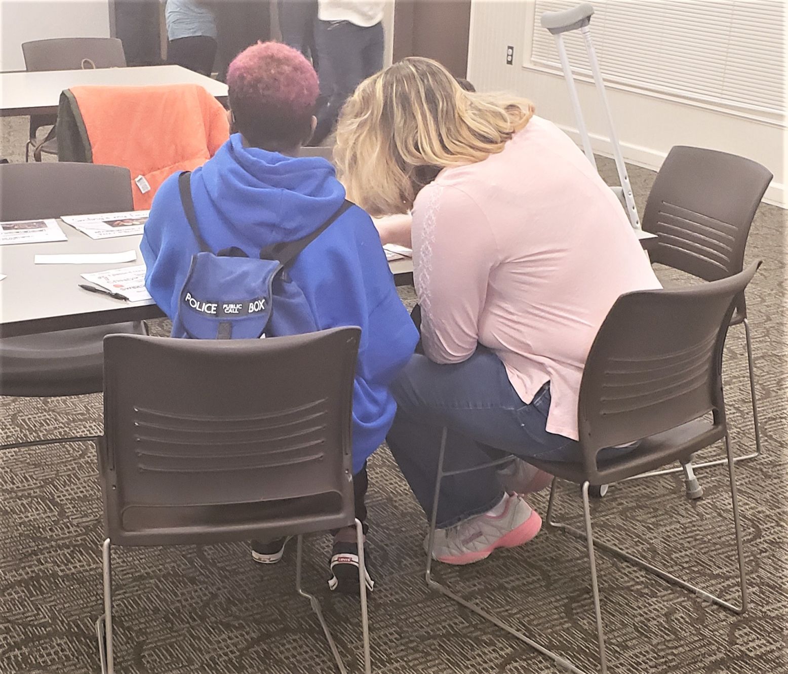 Teens work together to solve puzzles